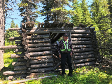Roland Karakuntie and the trapping cabin he built many decades ago, last used in the early 1970s.